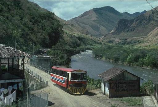 Autoferro on the line Ibarra - San Lorenzo passes the village road at  Rio Blanco, Ecuador.